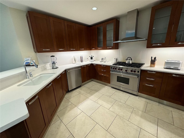 kitchen featuring appliances with stainless steel finishes, light tile floors, wall chimney exhaust hood, and sink