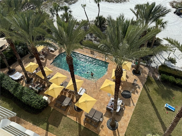 view of pool with a patio area and a lawn