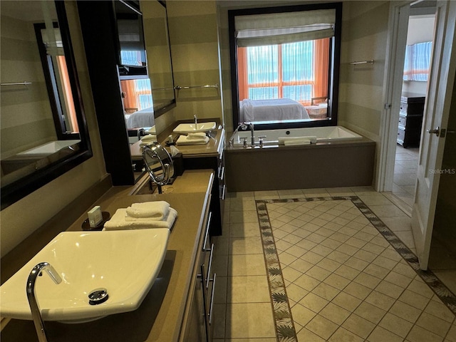 bathroom featuring vanity, tile flooring, and a bathtub