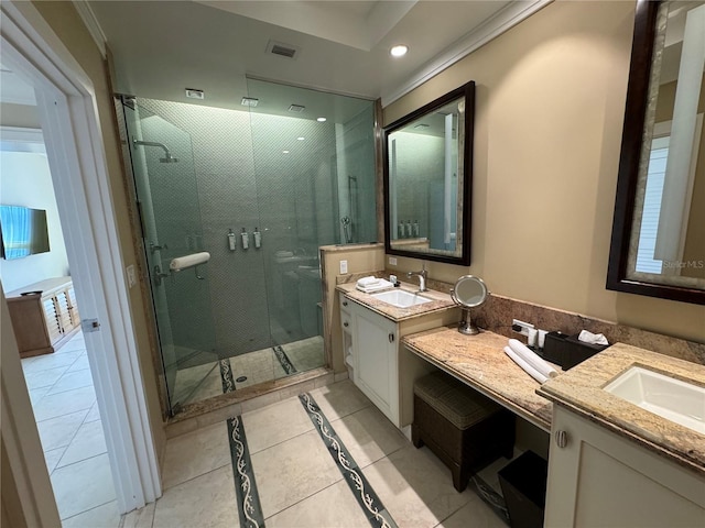 bathroom with a shower with door, tile floors, large vanity, and dual sinks