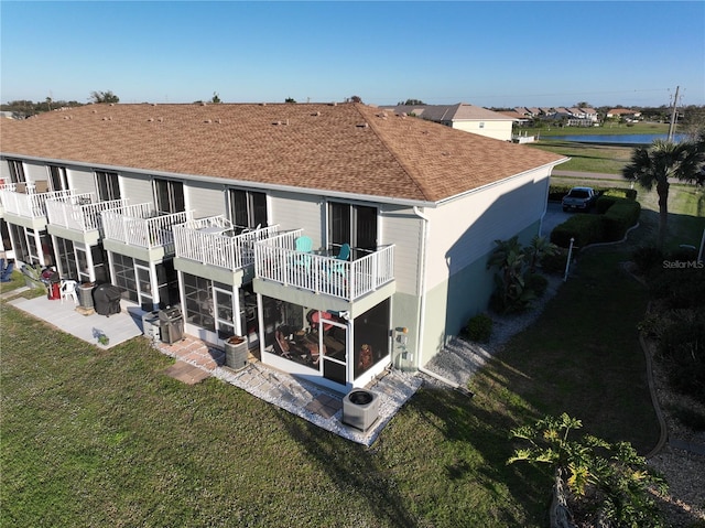 rear view of property with a lawn and a patio area