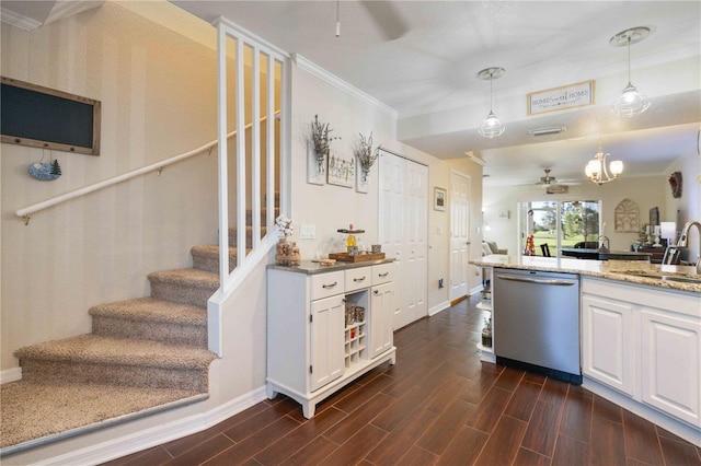 kitchen with pendant lighting, dark hardwood / wood-style floors, sink, white cabinets, and stainless steel dishwasher