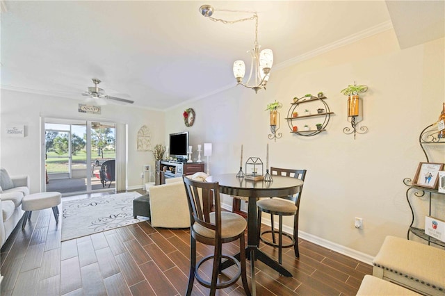 dining room featuring ornamental molding, ceiling fan with notable chandelier, and dark wood-type flooring