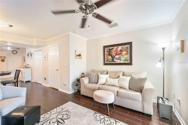 living room with ceiling fan, dark wood-type flooring, and crown molding