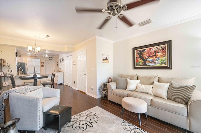 living room with ceiling fan with notable chandelier, ornamental molding, and dark hardwood / wood-style flooring