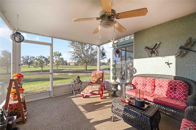 sunroom featuring ceiling fan