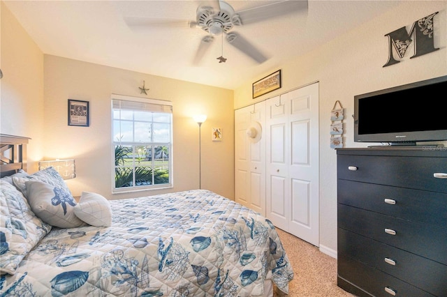 carpeted bedroom featuring ceiling fan and a closet