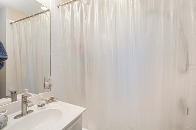 bathroom with vanity and curtained shower