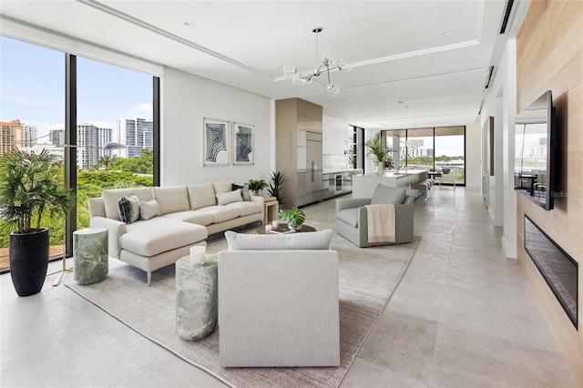 living room with a notable chandelier, a healthy amount of sunlight, and expansive windows