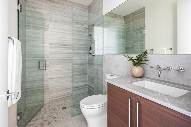 bathroom with vanity, a shower with shower door, toilet, and tile patterned floors