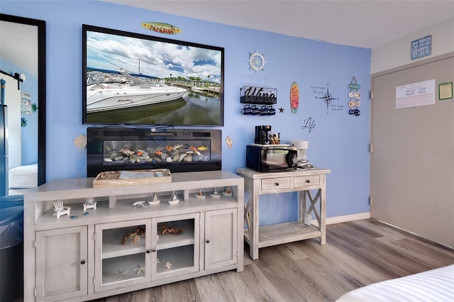 interior space featuring white cabinets and light hardwood / wood-style flooring