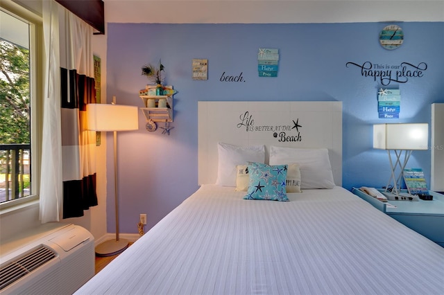 bedroom featuring hardwood / wood-style flooring and multiple windows