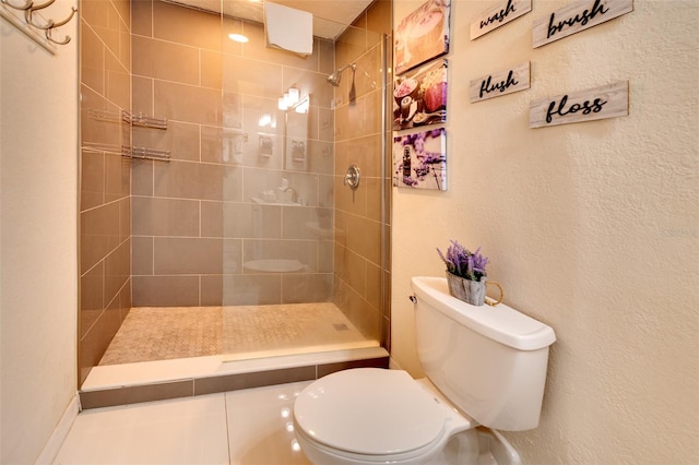 bathroom featuring toilet and tiled shower