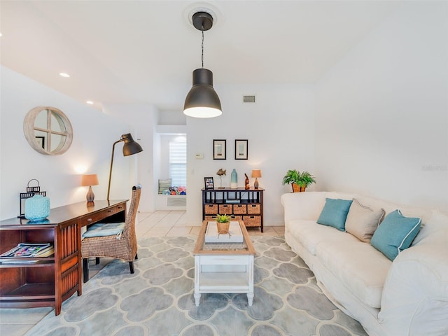 living room featuring vaulted ceiling and light tile floors