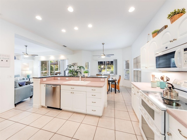 kitchen with ceiling fan, white appliances, white cabinetry, and sink