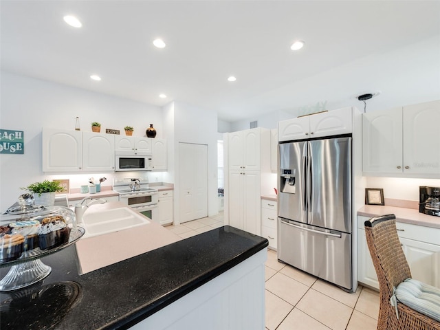 kitchen with white appliances, white cabinets, sink, and light tile flooring