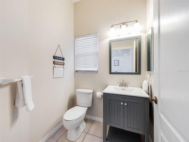 bathroom with toilet, tile flooring, and vanity