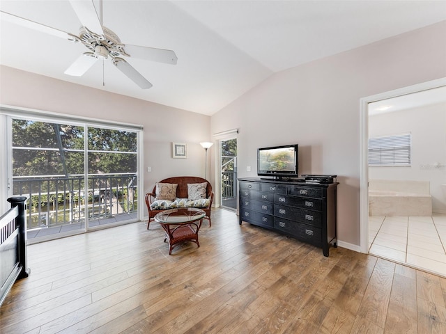 sitting room with vaulted ceiling, ceiling fan, a healthy amount of sunlight, and light hardwood / wood-style flooring