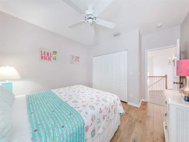 bedroom with a closet, ceiling fan, and light wood-type flooring