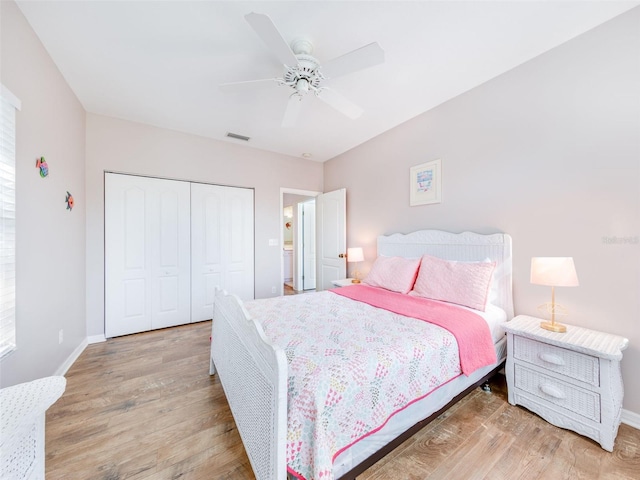 bedroom with a closet, ceiling fan, and light hardwood / wood-style flooring