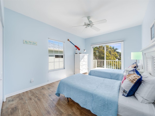 bedroom with access to exterior, ceiling fan, and light wood-type flooring