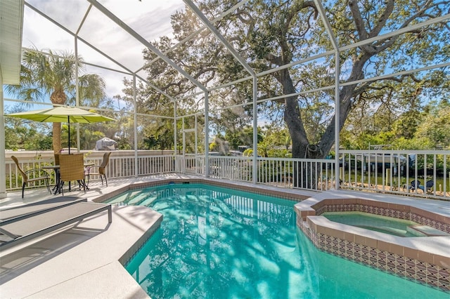 view of pool with an in ground hot tub and a lanai