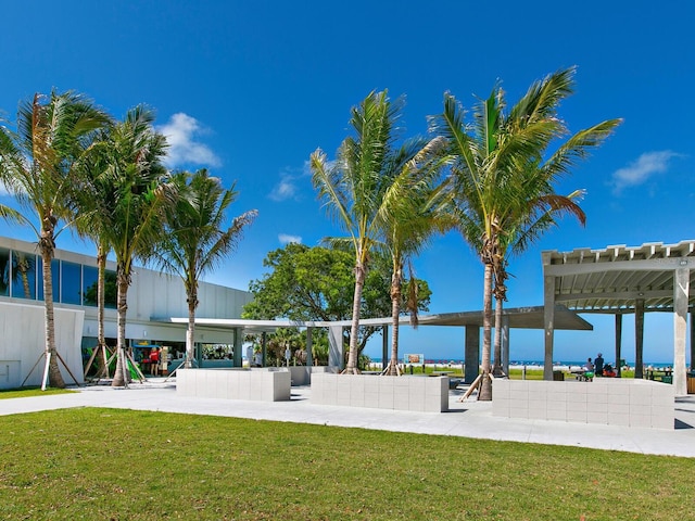 view of nearby features featuring a lawn, a water view, and a pergola