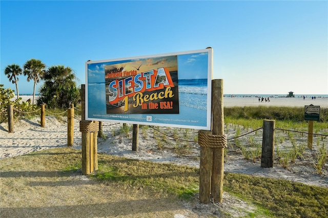 community sign featuring a water view