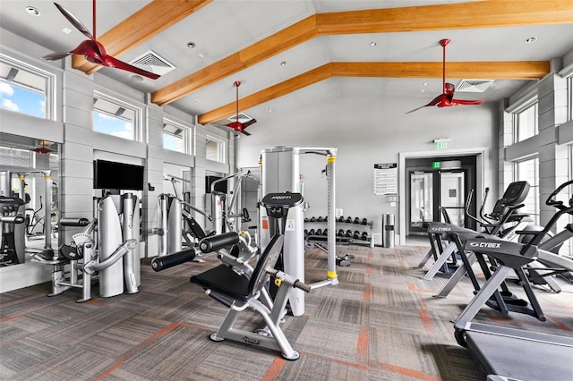 exercise room featuring plenty of natural light, dark colored carpet, and high vaulted ceiling