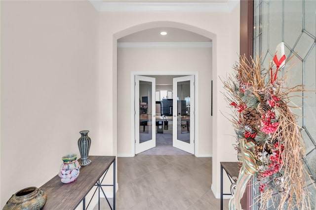 hallway with ornamental molding and french doors