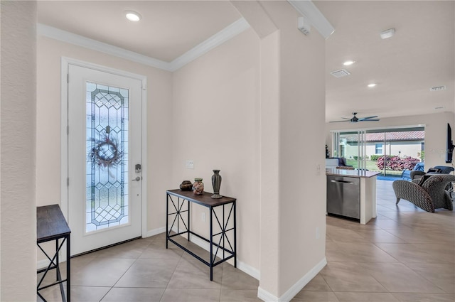 tiled foyer entrance featuring ceiling fan and ornamental molding