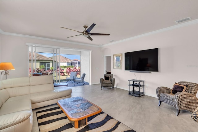 tiled living room with ceiling fan and crown molding