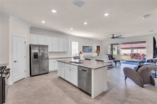 kitchen featuring sink, a healthy amount of sunlight, a center island with sink, and stainless steel appliances