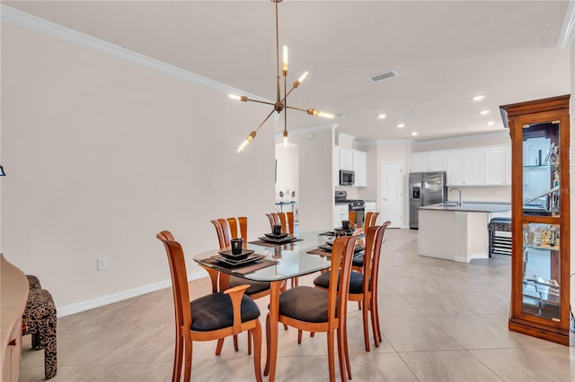 dining area with a notable chandelier, light tile patterned floors, and ornamental molding