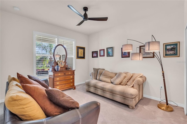 carpeted living room with ceiling fan