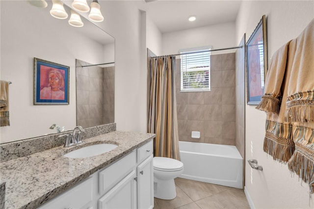 full bathroom featuring vanity, shower / bath combo with shower curtain, tile patterned floors, and toilet