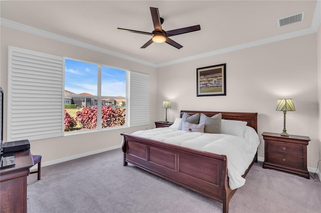 bedroom with light carpet, ceiling fan, and crown molding