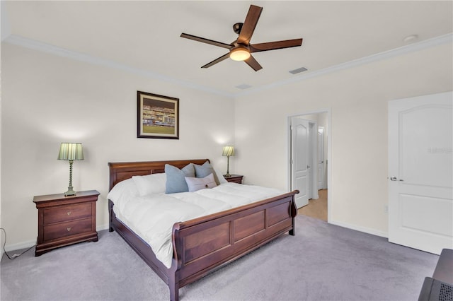 bedroom with ornamental molding, light colored carpet, and ceiling fan