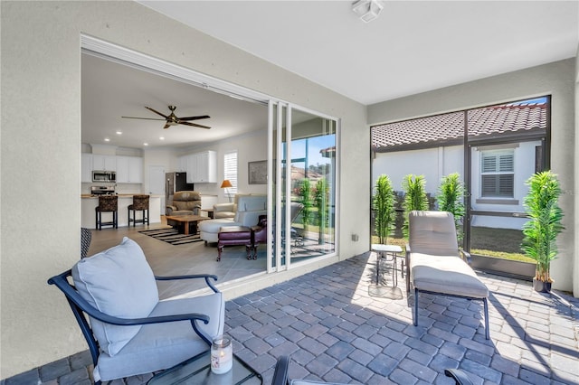 view of patio featuring ceiling fan