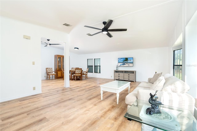 living room with ceiling fan and light hardwood / wood-style flooring