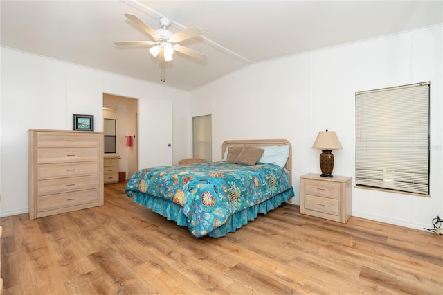 bedroom with lofted ceiling, ceiling fan, and light hardwood / wood-style flooring