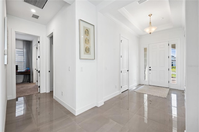 tiled entryway with a tray ceiling