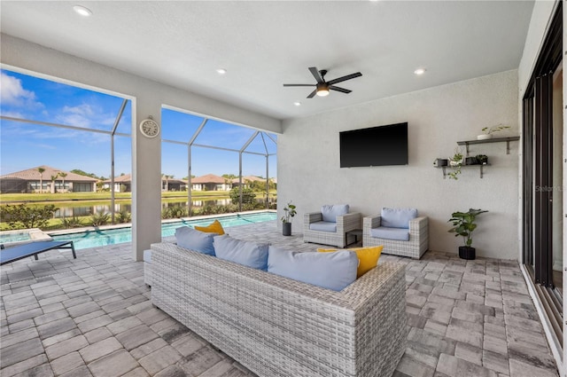 view of patio / terrace with an outdoor hangout area, ceiling fan, and glass enclosure