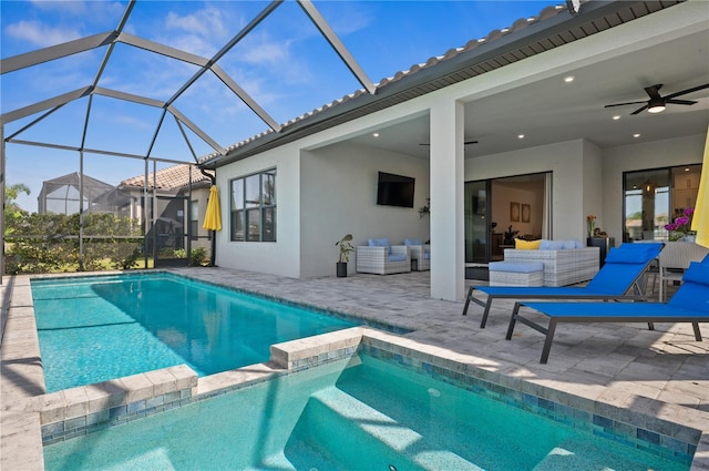 view of swimming pool featuring a patio area, outdoor lounge area, ceiling fan, and a lanai