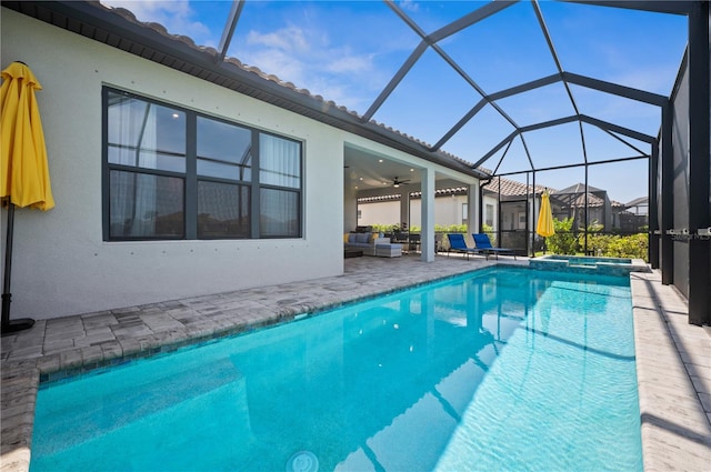 view of pool featuring a patio area, ceiling fan, and glass enclosure