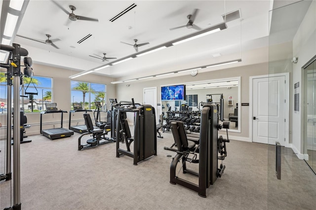 workout area with ceiling fan and carpet