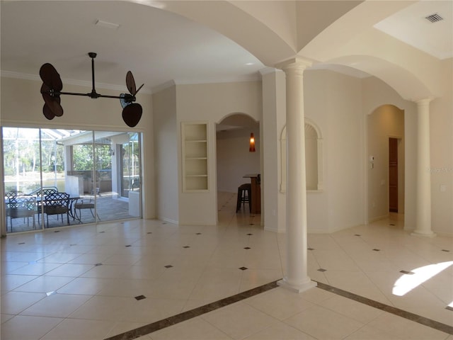 interior space with decorative columns, light tile patterned flooring, and crown molding