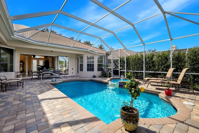 view of pool with a lanai, a patio, and an in ground hot tub