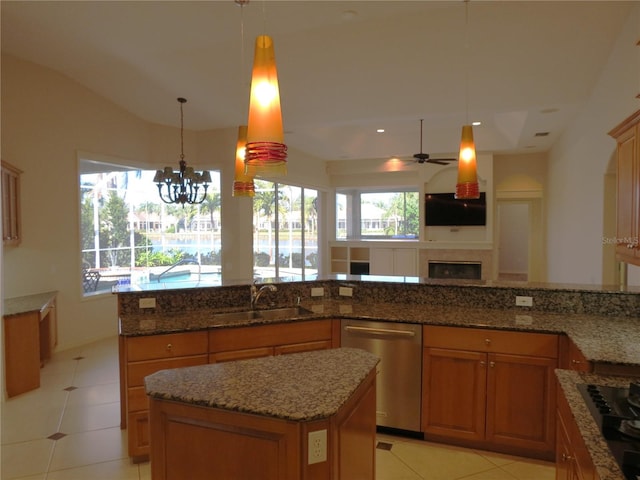 kitchen featuring sink, light tile patterned floors, dishwasher, hanging light fixtures, and a center island