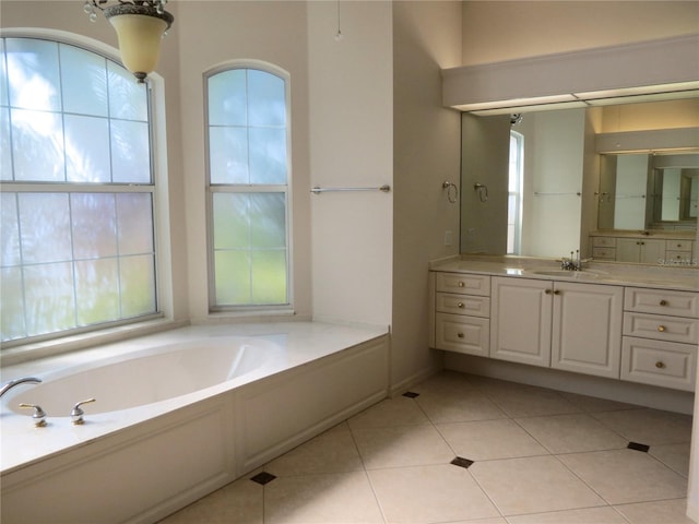 bathroom with vanity, tile patterned flooring, and a tub